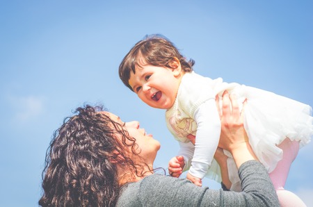 Mama playing with her daughterの写真素材