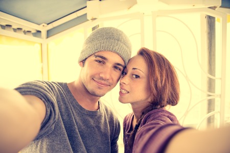 Couple taking a selfie on a panoramic wheel - Lovers having fun at amusement parkの写真素材