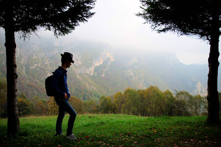 Man on top of the mountain - Backpacker looking at landscape - Conceptual designの写真素材