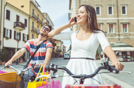 couple making shopping on the bicycleの写真素材