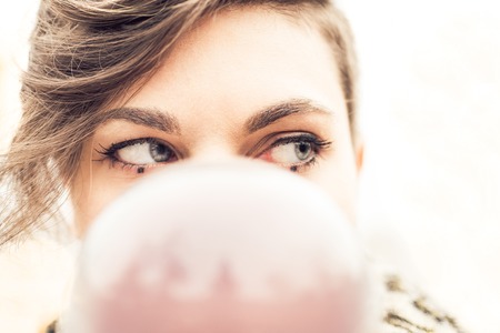 Portrait of young beautiful girl with blue eyes balancing a crystal ball on the hand - Woman performing contact jugglingの写真素材