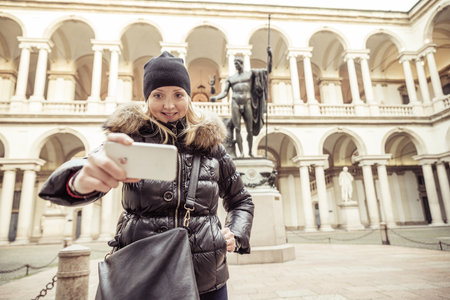 Young tourist taking a picture in front of Brera art gallery museum,Milan.のeditorial素材