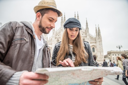 Happy tourists sightseeing city with map - Couple travelling in Italyの写真素材