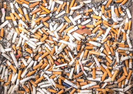 BANGKOK,THAILAND - MARCH 7, 2015: ashtray filled of cigarettes.Many governments impose restrictions on smoking tobacco, especially in public areas. The primary justification has been the negative health effects of second-hand smokeのeditorial素材