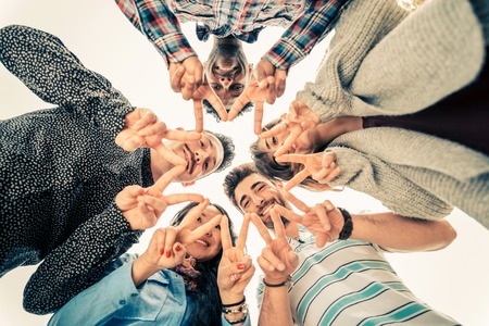 Multiracial group of people in circle making a star shape with hands gesture - Friends looking down with v-shapes finger position - Concepts about friendship,lifestyle,unity,business and teamworkの写真素材