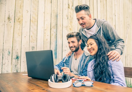 Group of young hipster people working with laptop - University students meeting in a wireless connected location to work with new technologies - Startup business and technologies conceptsの写真素材