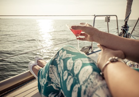 woman drinking cocktail on the boat. concept about leisure, summer, vacations and peopleの写真素材
