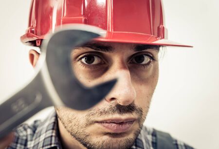 worker portrait with wrench. concept about occupations, jobs, construction and people