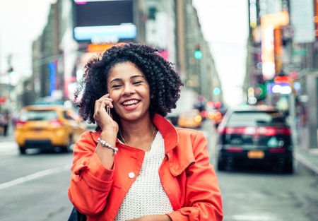 american woman making a phone call in Time Square, New york. urban lifestyle conceptの写真素材