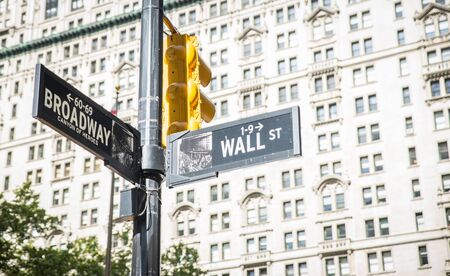 wall street and broadway cross in New York city. street indication boards. wall street is the maining and most important financial area of the cityの写真素材