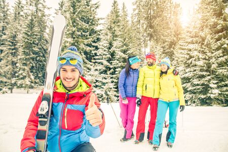 Young people on a winter vacation - Tourists having fun while skiing - Concepts about winter,christmas,winter vacation and skiingの写真素材