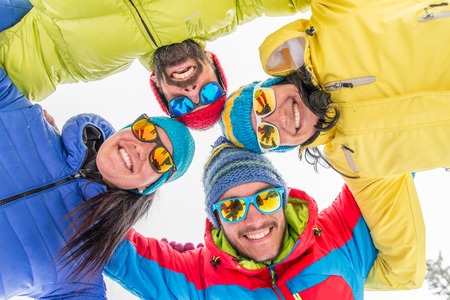 Young people on a winter vacation - Tourists having fun while skiing - Concepts about winter,christmas,winter vacation and skiingの写真素材