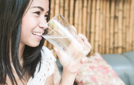 Asian woman holding a glass of water. concept about healthy lifestyleの写真素材
