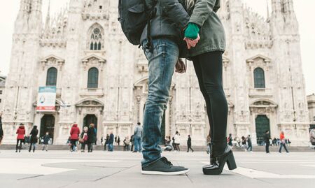 Couple kissing in Duomo square, Milan. Pavement and floor view with focus on the couple shoes.の写真素材