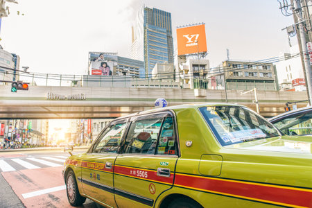 TOKYO, JAPAN - FEBRUARY 9, 2015: taxi car driving in Roppongi Hills, Tokyo. It is a district of Minato, Tokyo, Japan, famous as home to the rich Roppongi Hills area and an active night club sceneのeditorial素材