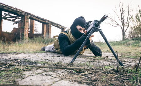 Sniper soldier shooting. Soft air player with rifle gun in action