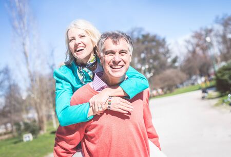 Senior couple portrait - Cheerful mature wife and husband walking outdoors and having funの写真素材