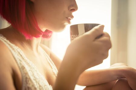 Woman drinking coffee in the morningの写真素材