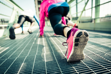 Group of runners traning in an urban area on the starting lineの写真素材