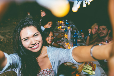 Taking self portrait at the evening barbecueの写真素材