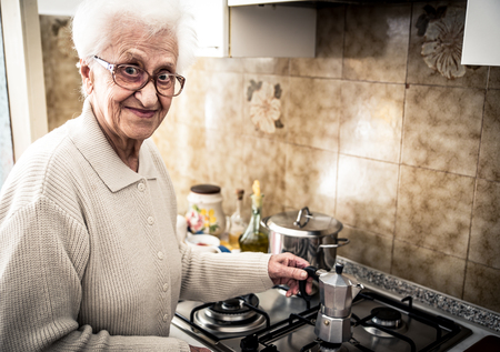 Old woman preparing coffeeの写真素材