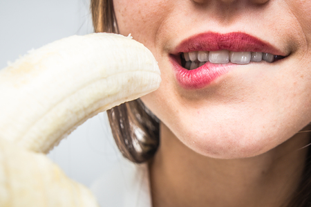 Woman eating bananaの写真素材