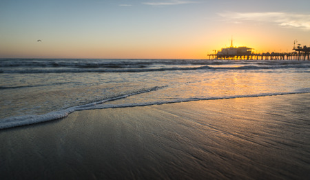 Santa monica sunset on the beach with pier on the backgroundの写真素材