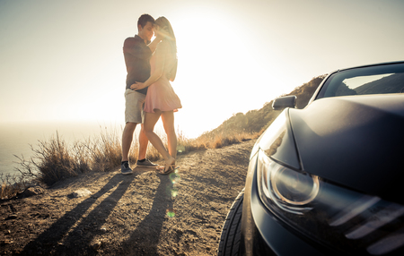 Romantic escape in los angeles. couple kissing outdoor on a cliffの写真素材