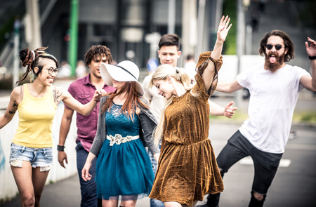 Group of  friends laughing out loud outdoor, sharing good and positive mood.の写真素材