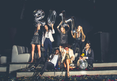 Multi-ethnic group of friends celebrating the end of the year in a nightclub - Sylvester party,...