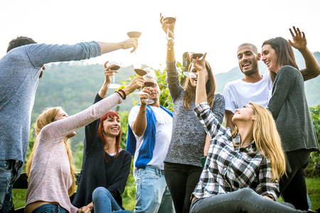 Group of friends at restaurant outdoors - People having dinner in a home gardenの写真素材