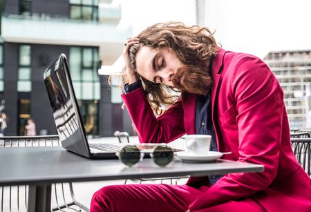 Young hipster man working at pc laptop in a cafÃ¨ outdoorsの写真素材