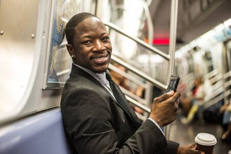 Businessman in full suit in New York subway metroの写真素材