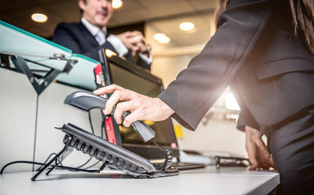 Secretary answering the phone in an officeの写真素材