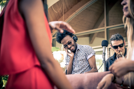Friends dancing in a lounge bar, with dj setの写真素材