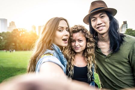Multi-ethnic group of friends in Central Park, Manhattan - Young cheerful people bonding outdoorsの写真素材