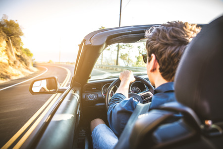 Couple of lovers driving on a convertible car - Newlywed pair on a romantic dateの写真素材