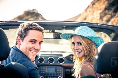 Couple of lovers driving on a convertible car - Newlywed pair on a romantic date