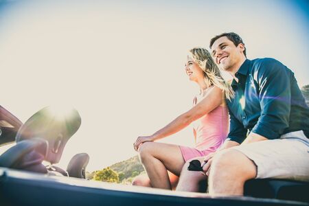 Couple of lovers driving on a convertible car - Newlywed pair on a romantic date