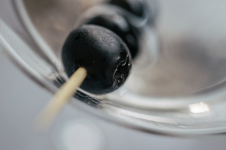 Martini cocktail and olives close up