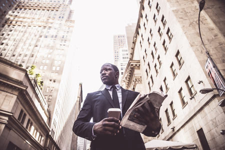 Businessman in full suit walking in Wall Street, New Yorkの写真素材