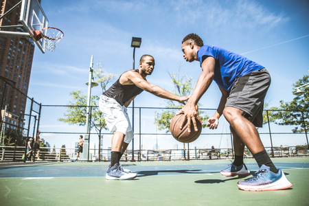 Two afroamerican athlethes playing basketball outdoors - Basketball athlete training on court in New Yorkの写真素材