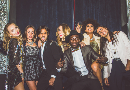 Multi-ethnic group of friends celebrating in a nightclub - Clubbers having partyの写真素材