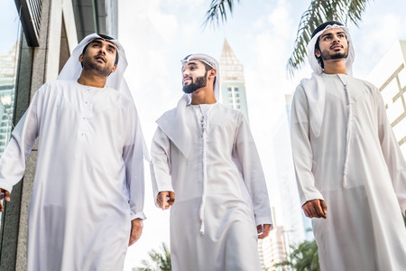 Three arabic men bonding outdoors - Businesspeople walking and talking in Dubaiの写真素材
