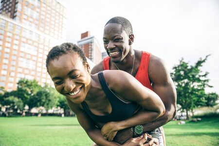 Sportive couple playing and having fun in a parkの写真素材
