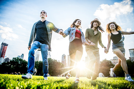 Multi-ethnic group of friends in Central Park, Manhattan - Young cheerful people bonding outdoorsの写真素材
