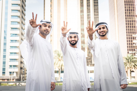 Three arabic men bonding outdoors - Businesspeople walking and talking in Dubaiの写真素材