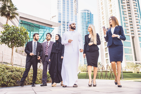 Multiethnic group of businesspeople meeting outdoors in a modern cityの写真素材