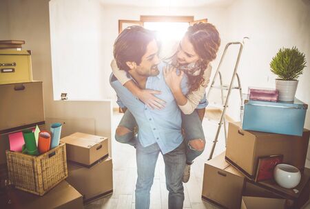 Young couple moving in into new apartment