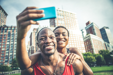 Couple running in New York - Sportive man and woman training outdoors and having fun while resting